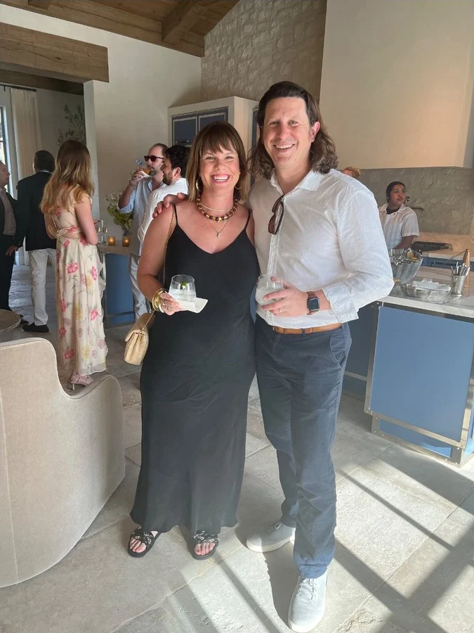 A couple posing for their sign-up photo at an engagement party