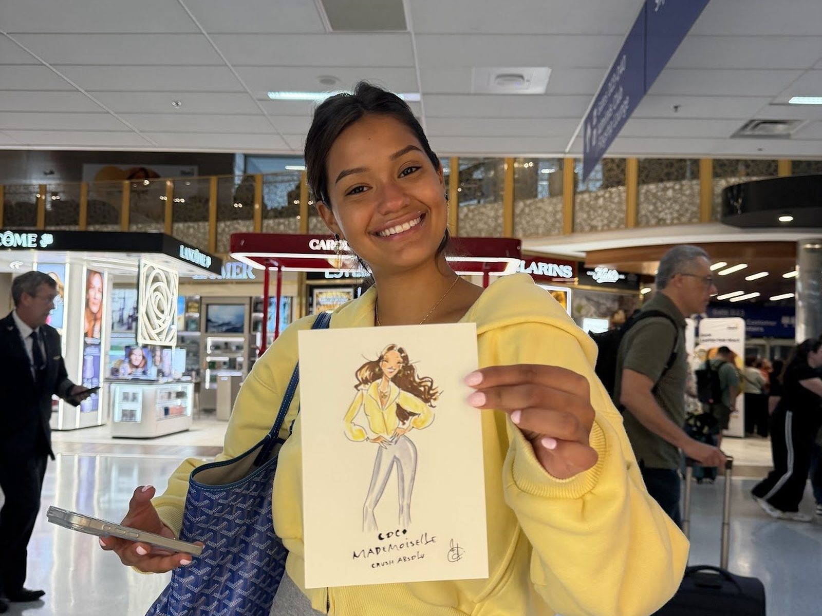A guest in the Chanel boutique looking at her sketch