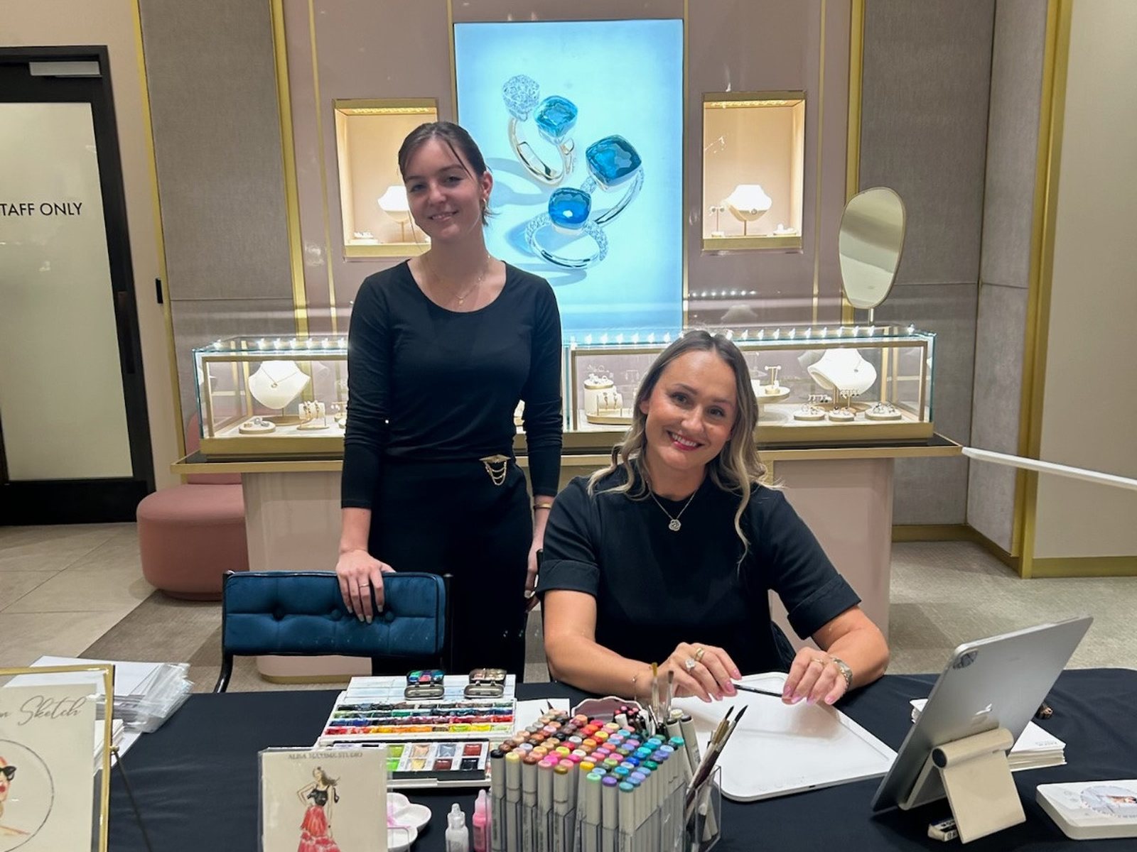 Two artists set up at the counter of a jewelry store