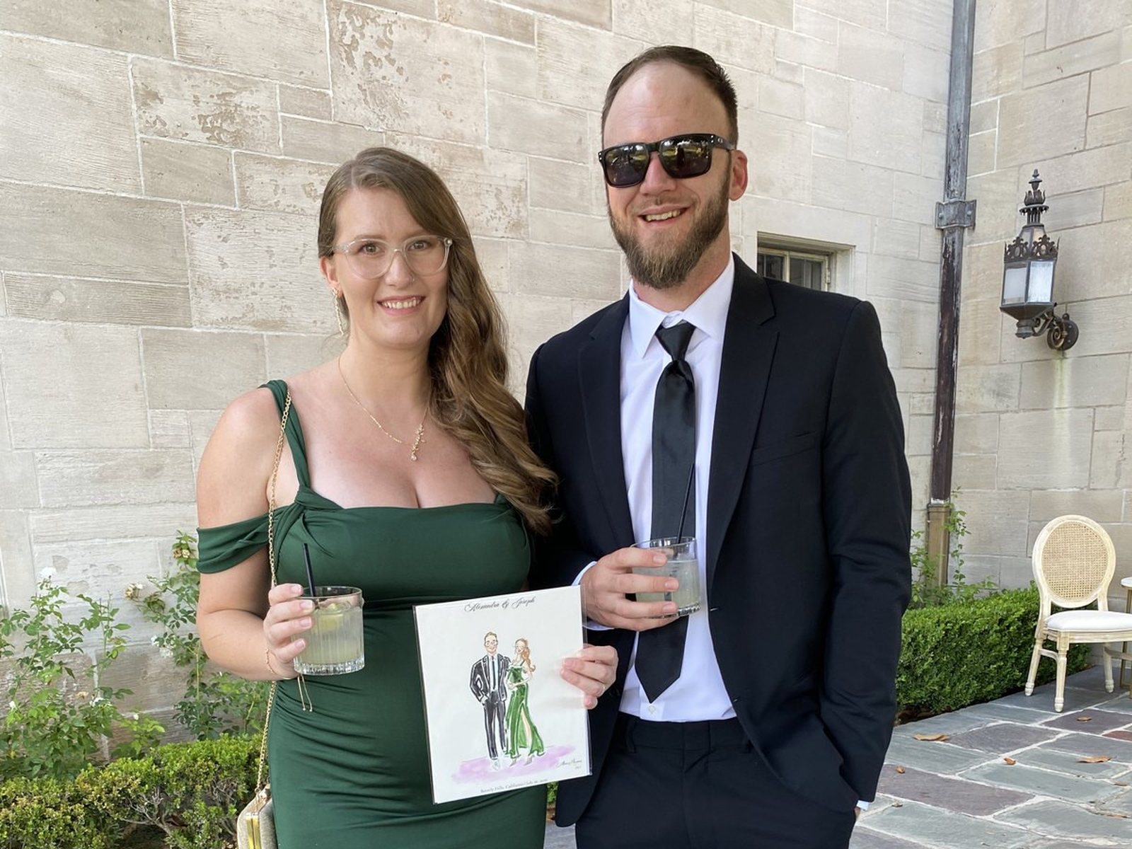 A couple at a wedding holding their finished sketch